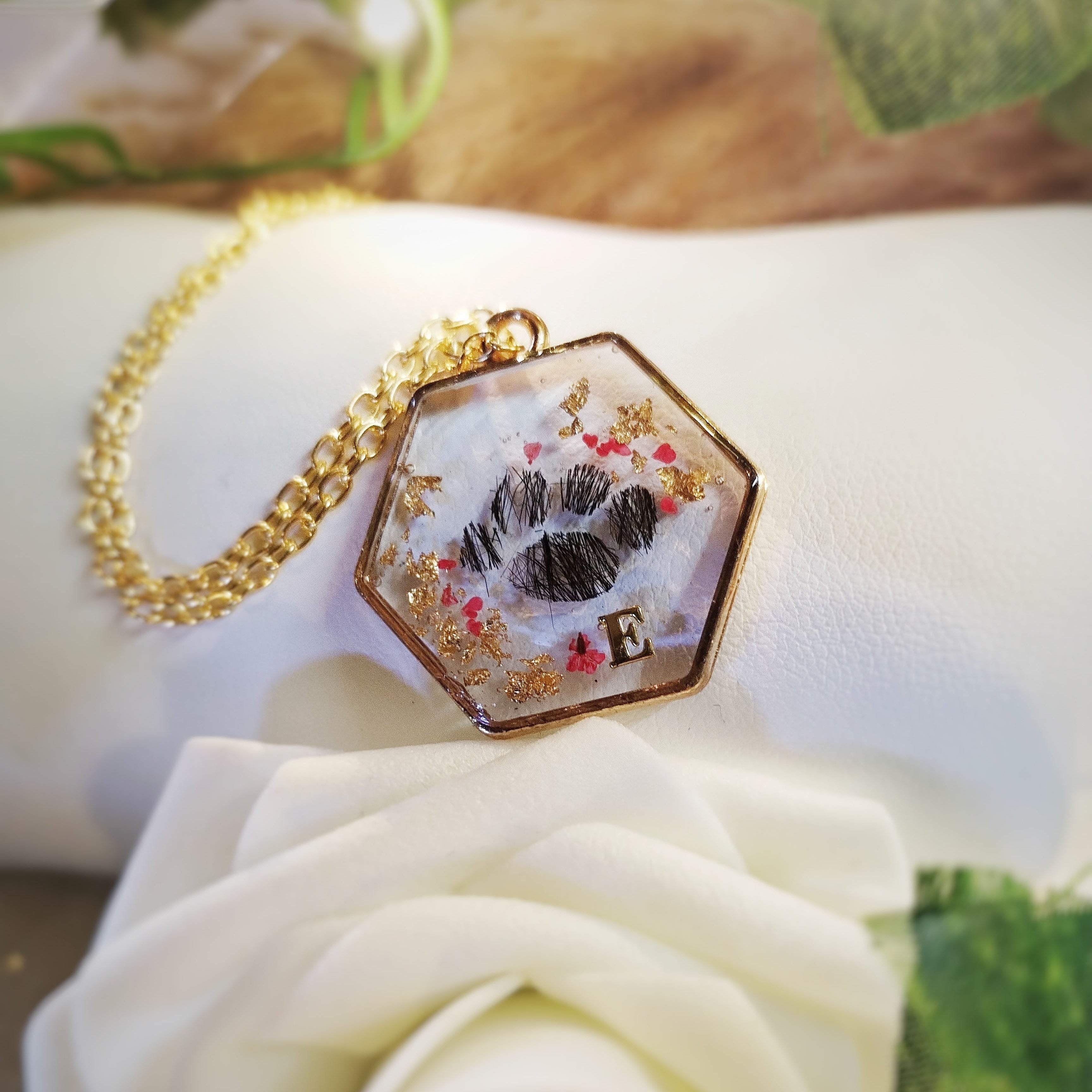 Bracelet en acier inoxydable, poils et/ou cendres d'animaux en inclusion dans la résine. Forme de patte.